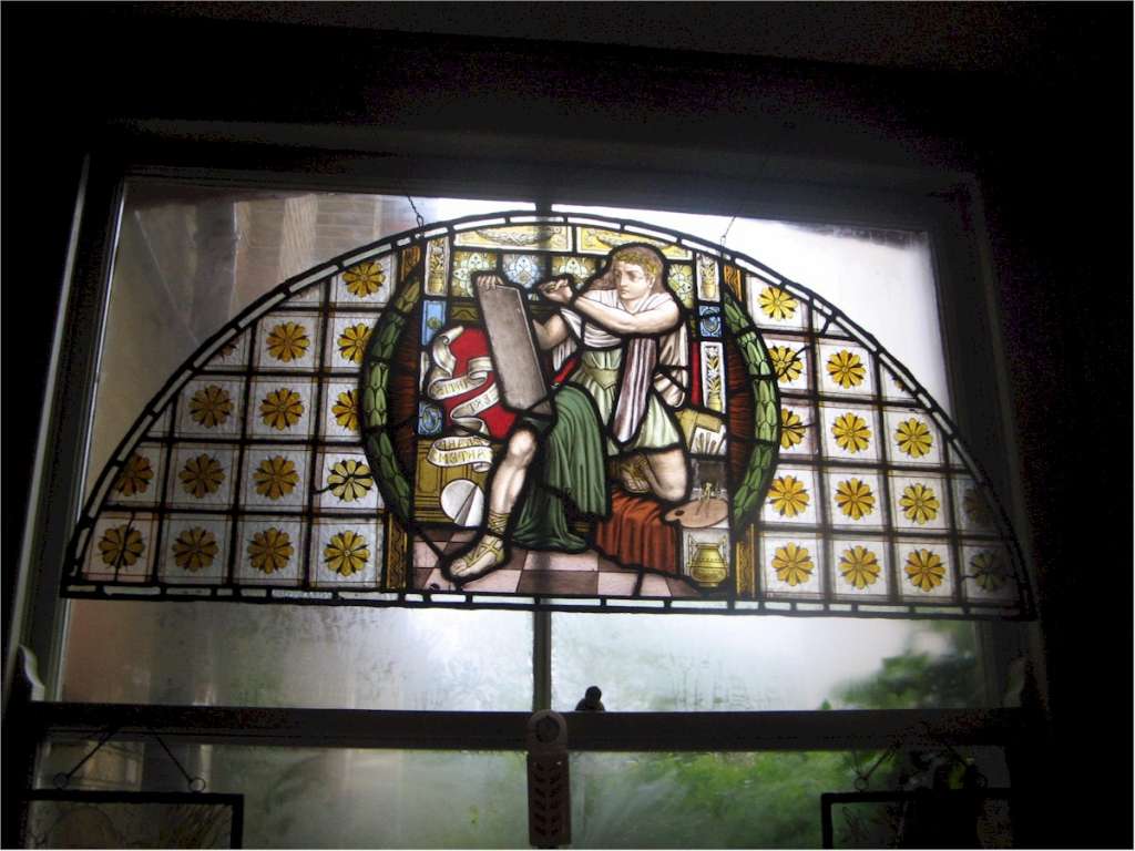 Victorian pre-raphaelite stained glass of a scribe