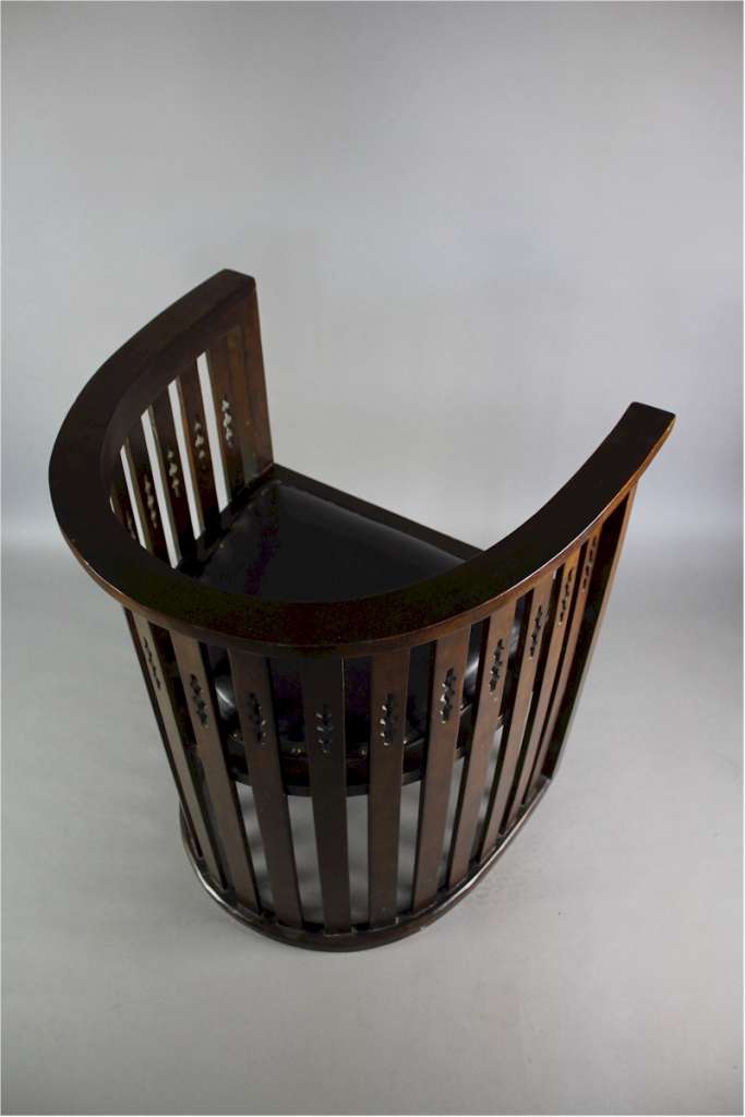 Arts and Crafts mahogany barrel chair with pierced cutouts. c1910