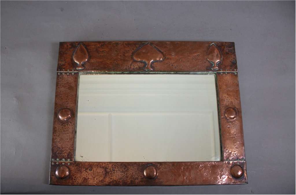 Arts and crafts copper mirror with raised spear motifs