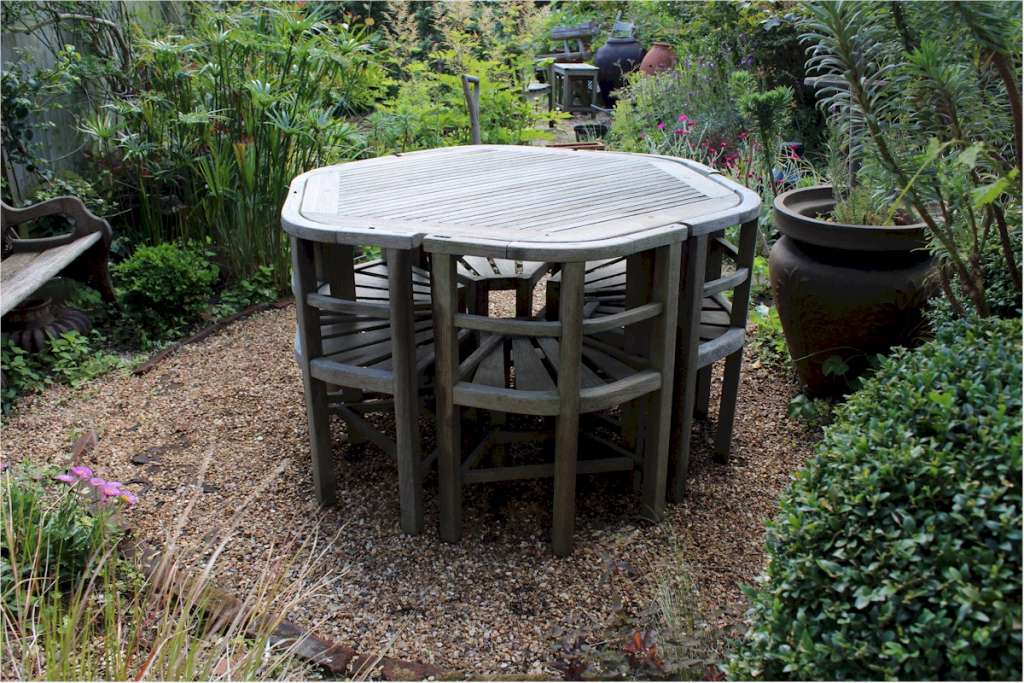 Rare teak garden set of table and six wrap round chairs retailed by Heals made by Hughes Bolckow