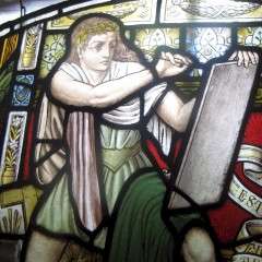 Victorian pre-raphaelite stained glass of a scribe