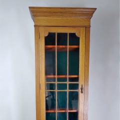 Narrow and tall arts and crafts bookcase in golden oak
